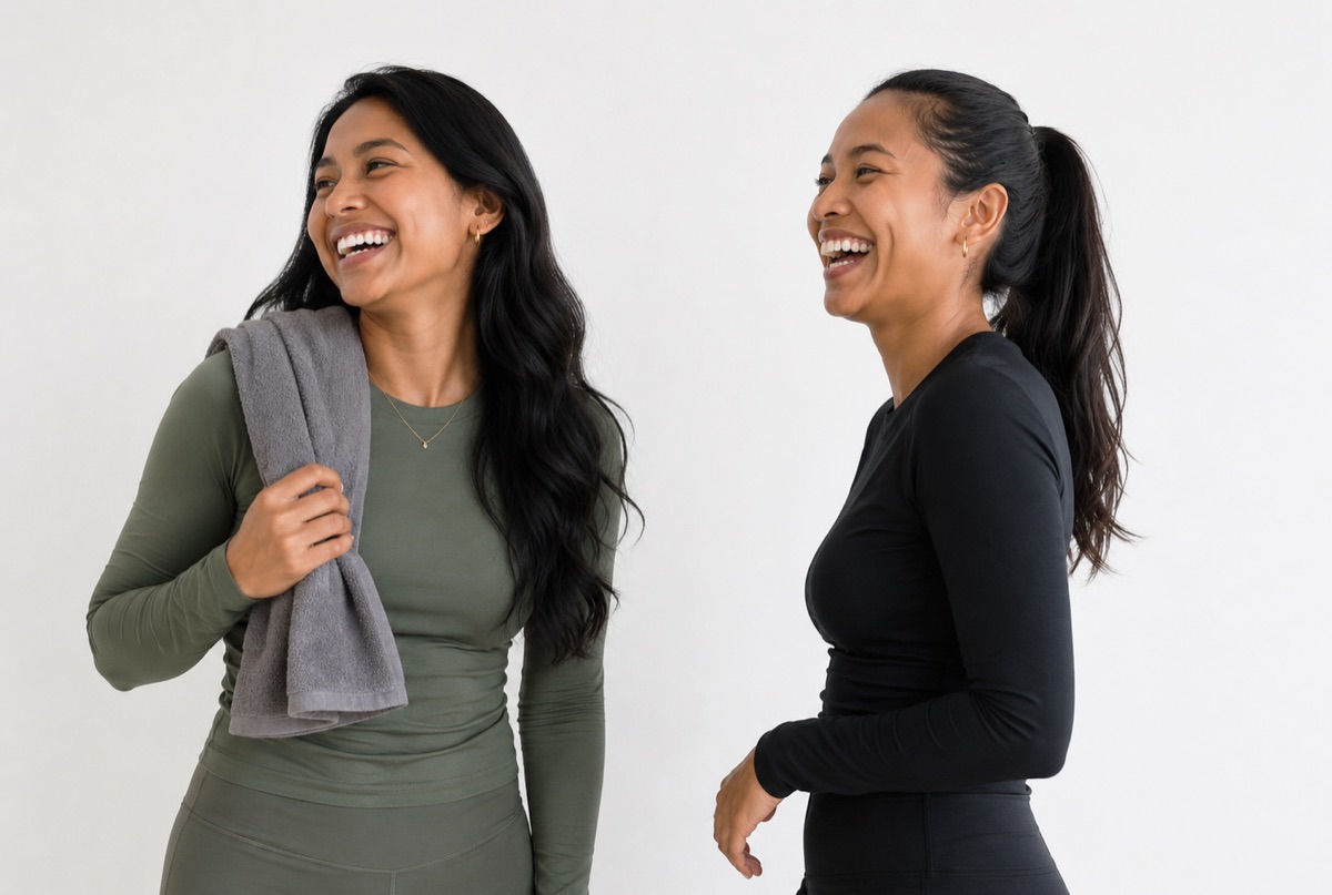 Two women in modest activewear laughing together